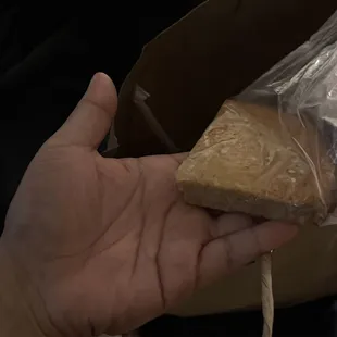 a hand holding a piece of bread