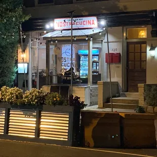 Nostra Cucina ("Our Kitchen"), a modest storefront with outdoor seating.