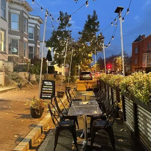 tables and chairs on a sidewalk