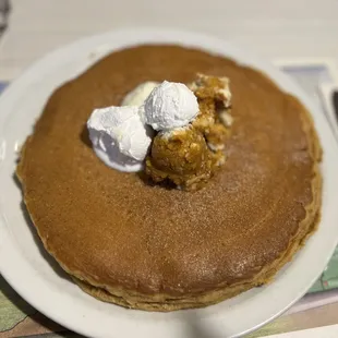 a pancake with whipped cream on top
