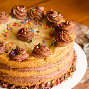 a cake with chocolate frosting and sprinkles
