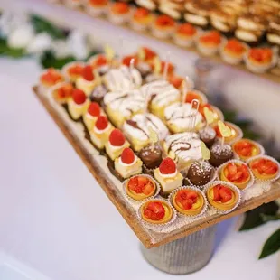 Cheesecake squares with raspberry topping, custom made tres leches with chocolate drizzle, chocolate decadence and lemon tarts