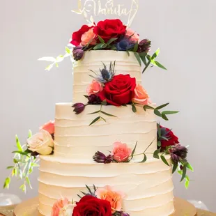 a wedding cake with fresh flowers