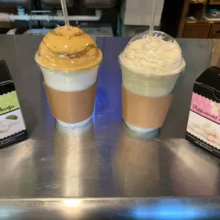 two cups of coffee and a box of cookies