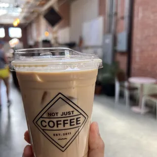a hand holding a cup of coffee