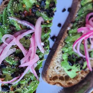 a sandwich with avocado and onions