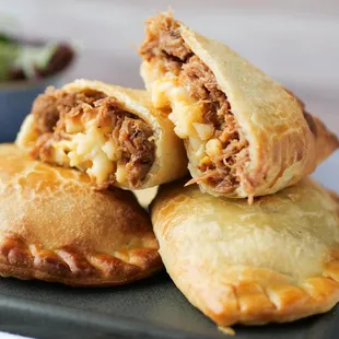 a close up of a meat and cheese pastry