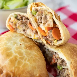 a close up of a meat and vegetable pie