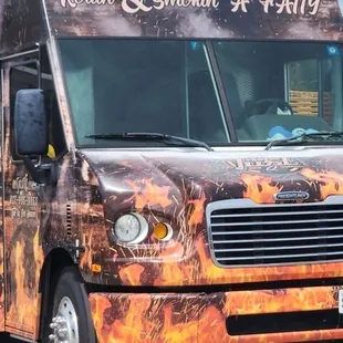 a food truck with flames painted on it