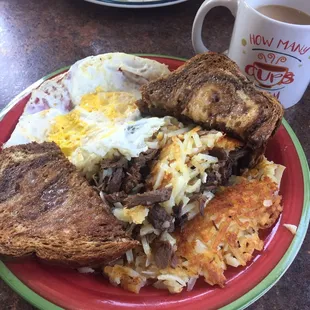 Homemade Roast Hash with eggs and marble rye toast .