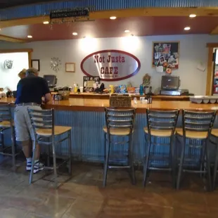 Front desk, registers, and bar type seating.