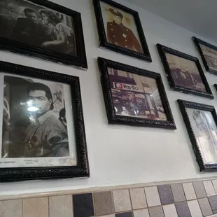 a wall of framed photos