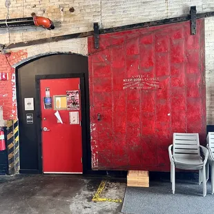 a red door in a brick building