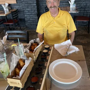 Flight of wings served in railway cars with several sauces
