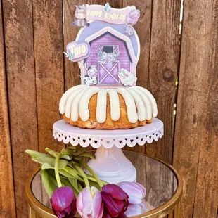 a bundt cake on a table with tulips