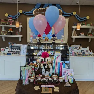 a dessert counter with balloons