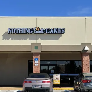 two cars parked in front of the store