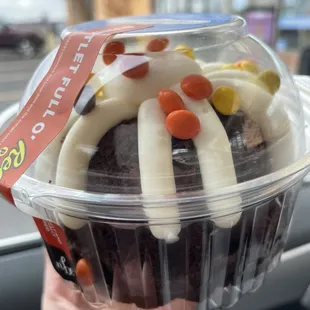 a person holding a cupcake
