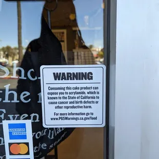 a warning sign in a store window