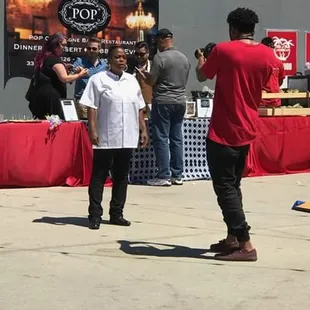 a man standing in front of a food stand