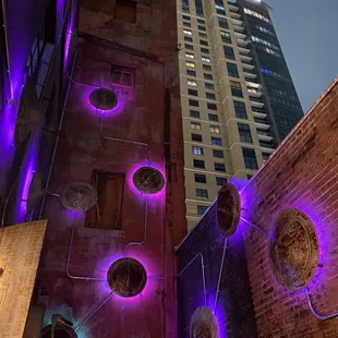 a view of a building with purple lights