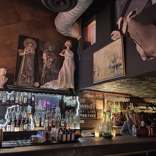 a woman in a white dress standing at a bar