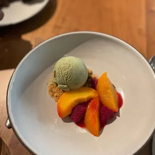 a plate of fruit and ice cream