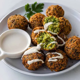 Falafel side with Tahini sauce, it comes in Pita bread in a wrap, plate or side order.