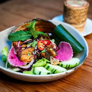 Larb Pla, Deep fried Branzino with roasted rice mixed with spicy lime dressing served with sticky rice. Yum Yum