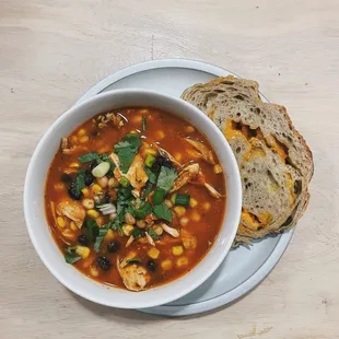 a bowl of soup with bread