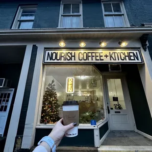 a person holding a cup of coffee