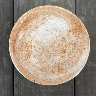 a cappuccino on a wooden table