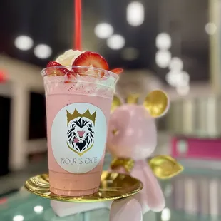 a pink drink with strawberries on top