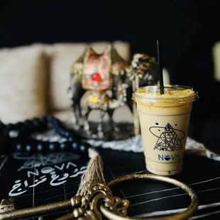 a cup of iced coffee and a pair of scissors