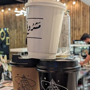 a stack of coffee cups and a blender