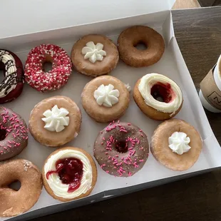 a box of doughnuts and a cup of coffee