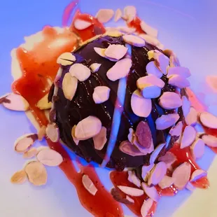 a dessert with chocolate and almonds on a white plate