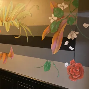 a mural of flowers and leaves