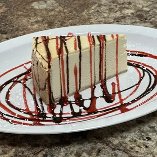 Cheesecake with raspberry and chocolate sauce