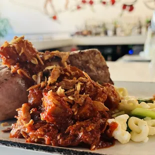 Center Cut Duroc Pork Chop* spicy pork belly braise, baby bok choy, rice spaetzle, crispy shallots