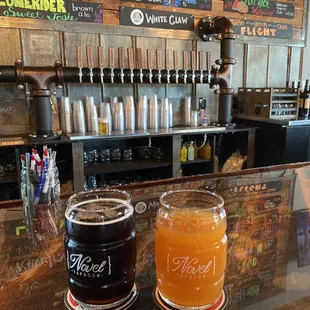 two glasses of beer on a bar