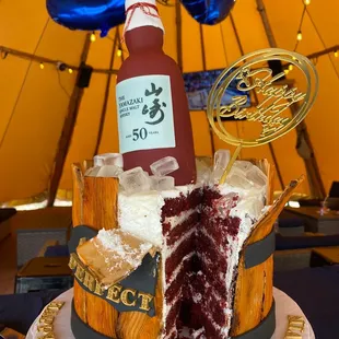 a bottle of ketchup on top of a cake
