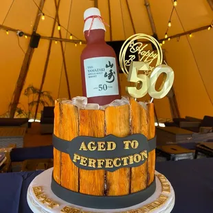 a bottle of ketchup on top of a cake