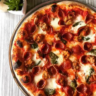 a pepperoni and spinach pizza