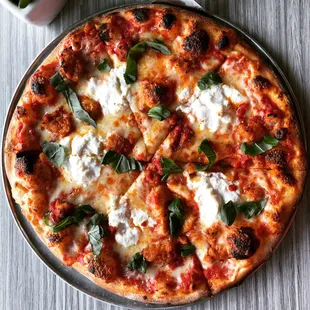 a pizza with cheese and basil