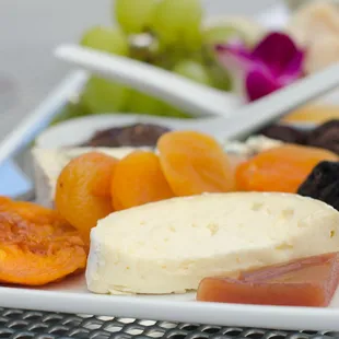 a plate of fruit and cheese