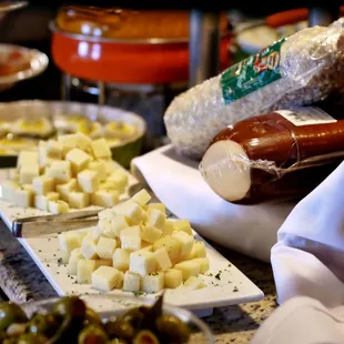 Imported cheeses at the all you can eat fresh market table at Novilhos Brazilian Steakhouse in Bellevue, WA