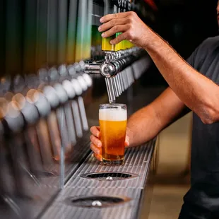 a man pouring a beer