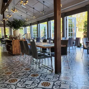 a dining room with tables and chairs