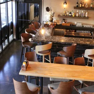 a view of a bar with chairs and a counter